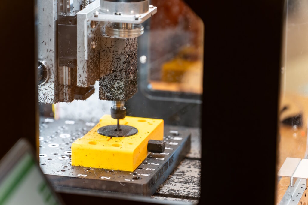 Closeup of a drill boring into a piece of metal